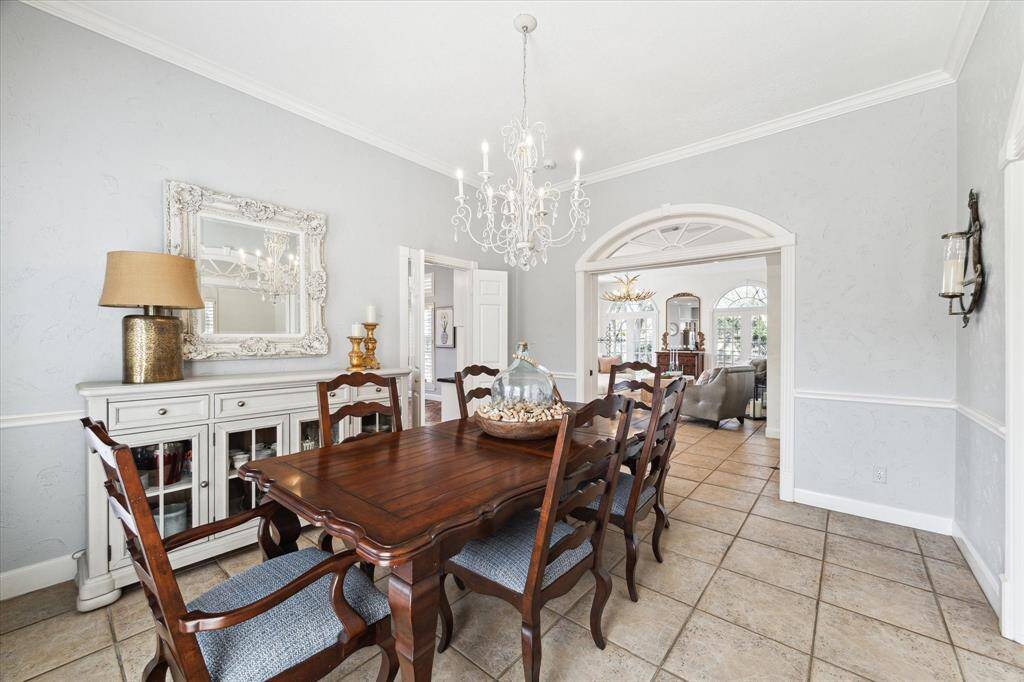 Formal dining with beautiful wood molding and crystal chandelier.