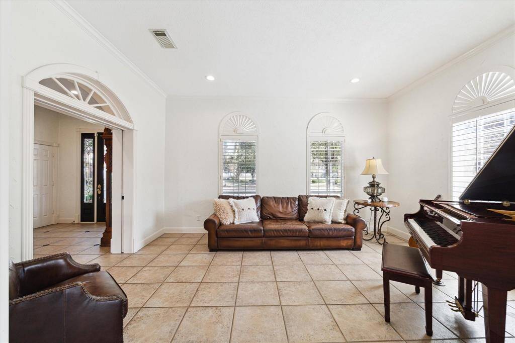 Private formal living room has pocket doors and plantation shutters.