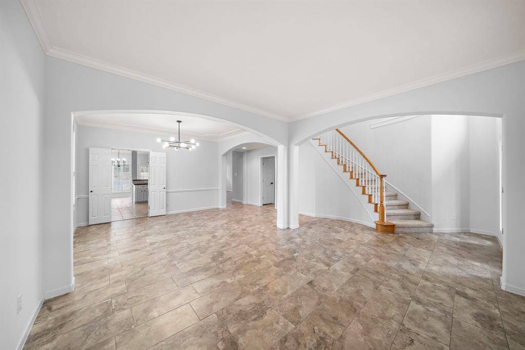 Versatile and inviting, this bright flex space offers endless possibilities as a sitting area, home office, or library. Flowing seamlessly into the formal dining room, the open layout creates an effortless connection to the kitchen—perfect for entertaining or everyday living.