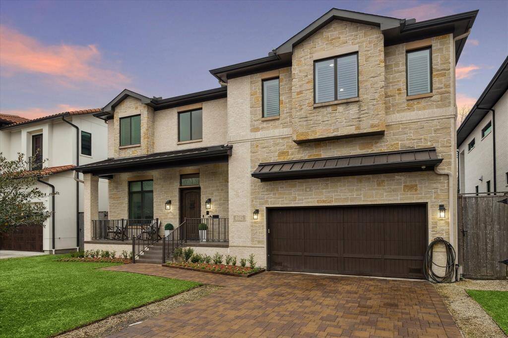 A beautifully paved driveway leads to the striking façade, where stone accents complement the timeless brick construction. A true showcase of style and sophistication, this residence makes a lasting first impression.