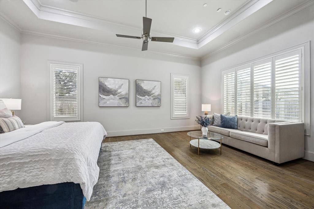 Another view of the primary bedroom showing the space and large windows...