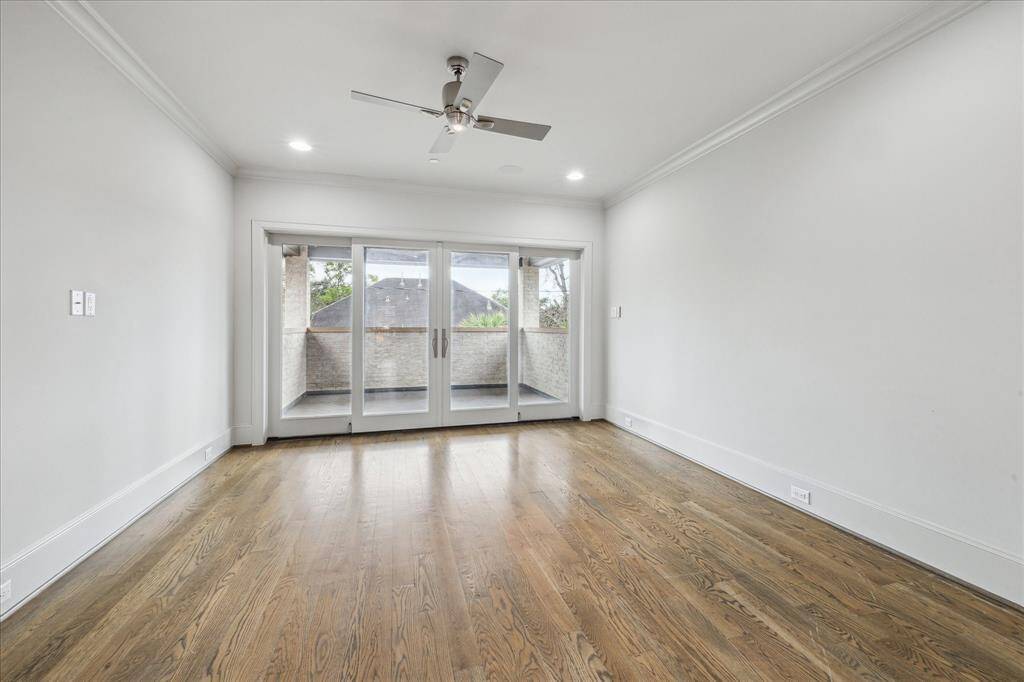GAME ROOM:The spacious game room is designed for endless entertainment, featuring rich hardwood floors that add warmth and elegance to the space. With ample room for games, lounging, and gatherings, it’s the perfect spot for family fun or hosting guests.