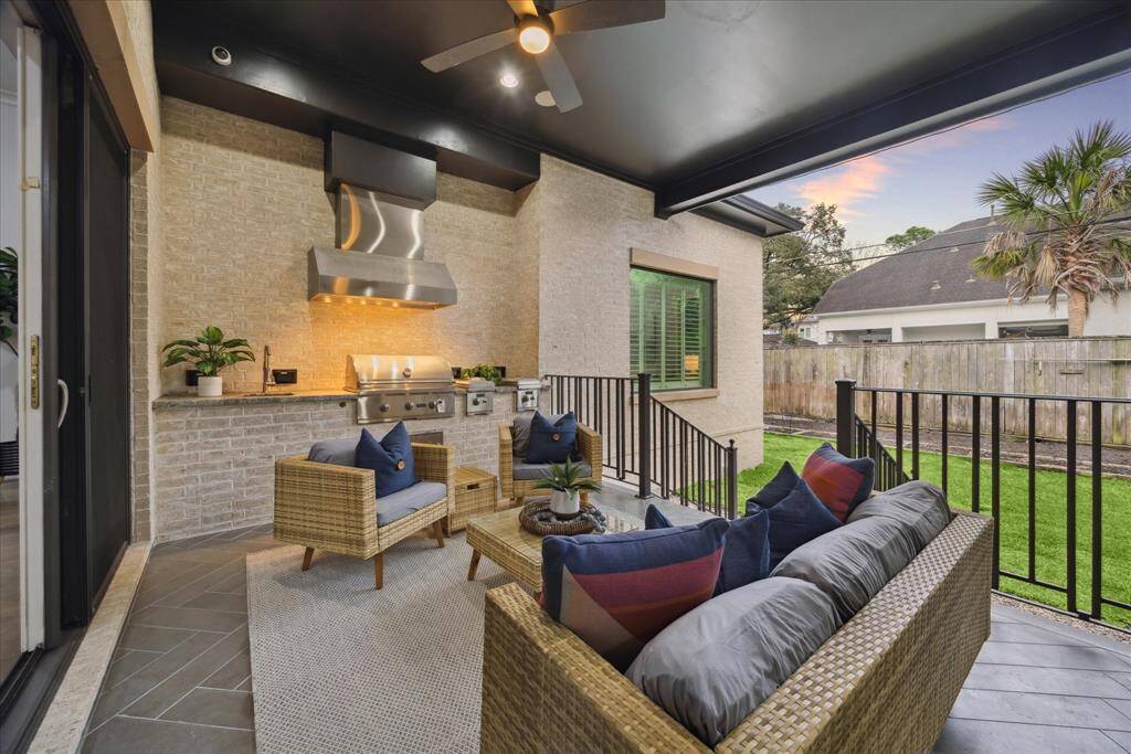 VERANDA/SUMMER KITCHEN: This stunning veranda with a fully equipped summer kitchen is the ultimate outdoor retreat, perfect for entertaining and year-round enjoyment. Designed for both comfort and style, the space features a built-in grill, ample counter space, and room for dining and lounging.