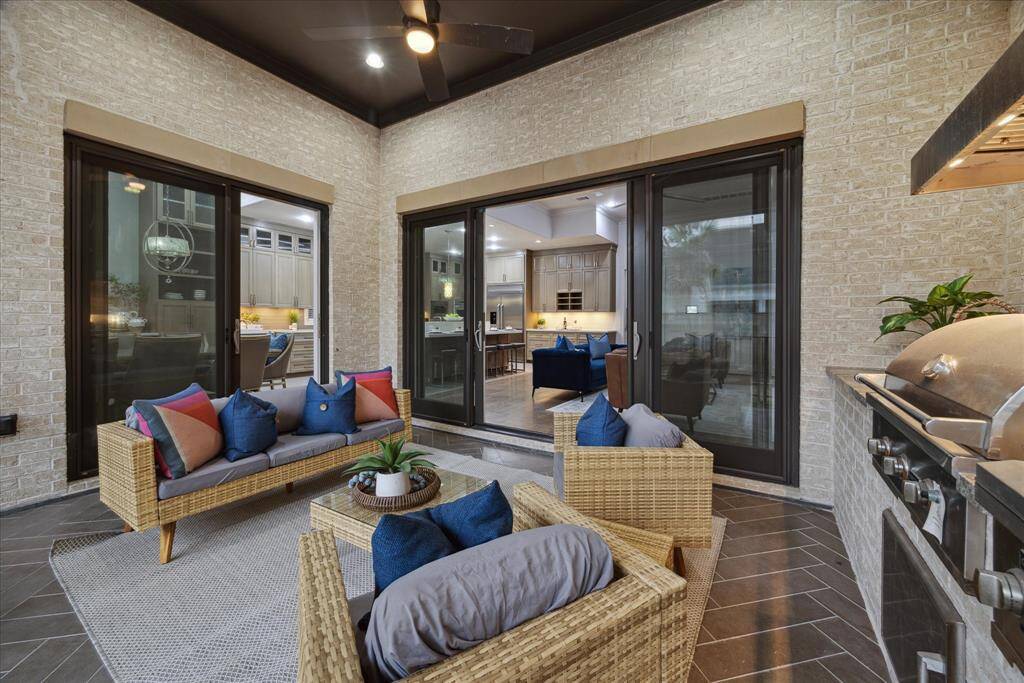 This beautiful veranda extends seamlessly from the family and dining rooms, creating a perfect blend of indoor and outdoor living.  Large openings enhance the connection to the home’s interior, allowing natural light to flow freely and providing a stunning backdrop for gatherings or quiet moments alike.