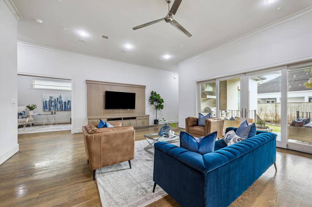FAMILY ROOM: The heart of the home, this stunning family room is bathed in natural light from expansive windows. Designed for both comfort and style, this inviting gathering area is perfect for relaxing, entertaining, and making lasting memories.