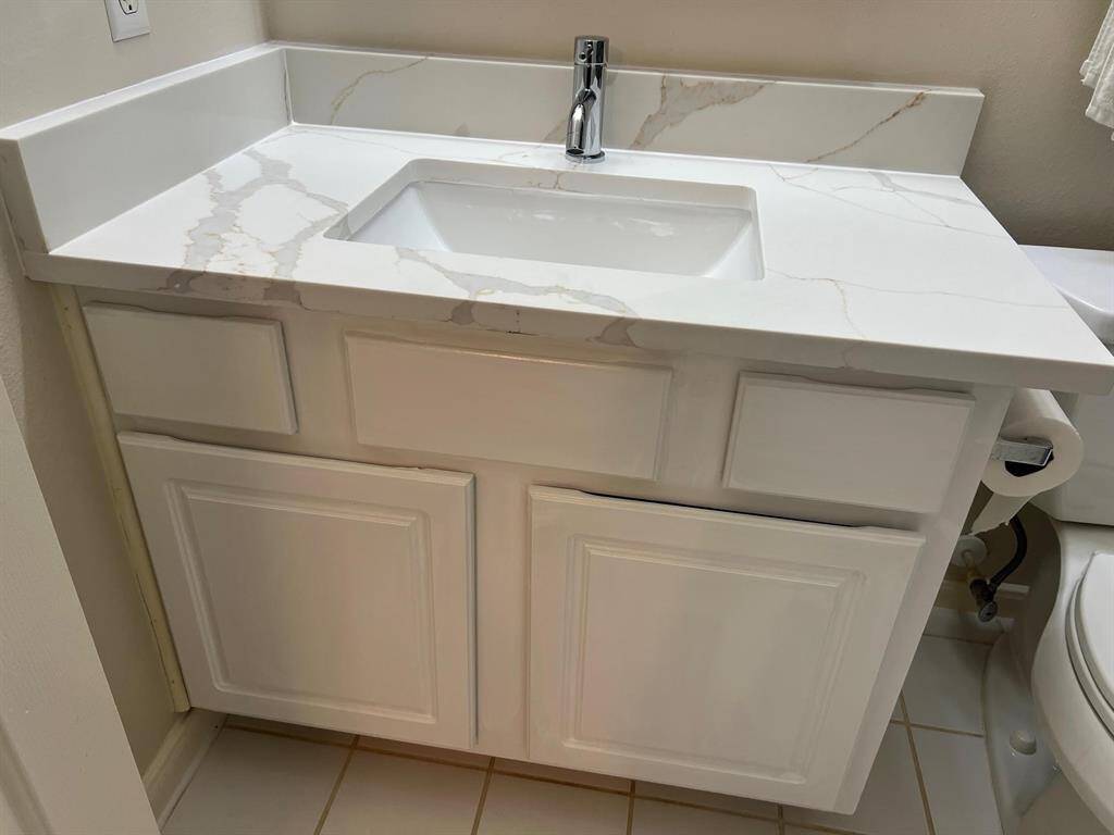 Newly installed 3 cm quartz counter on the second floor third bath with a new under mounted sink.  Very classy, indeed.