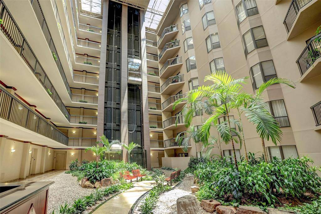 ATRIUM: Filled with Alexander palms & tropical landscaping.ATRIUM: Filled with Alexander palms & tropical landscaping.