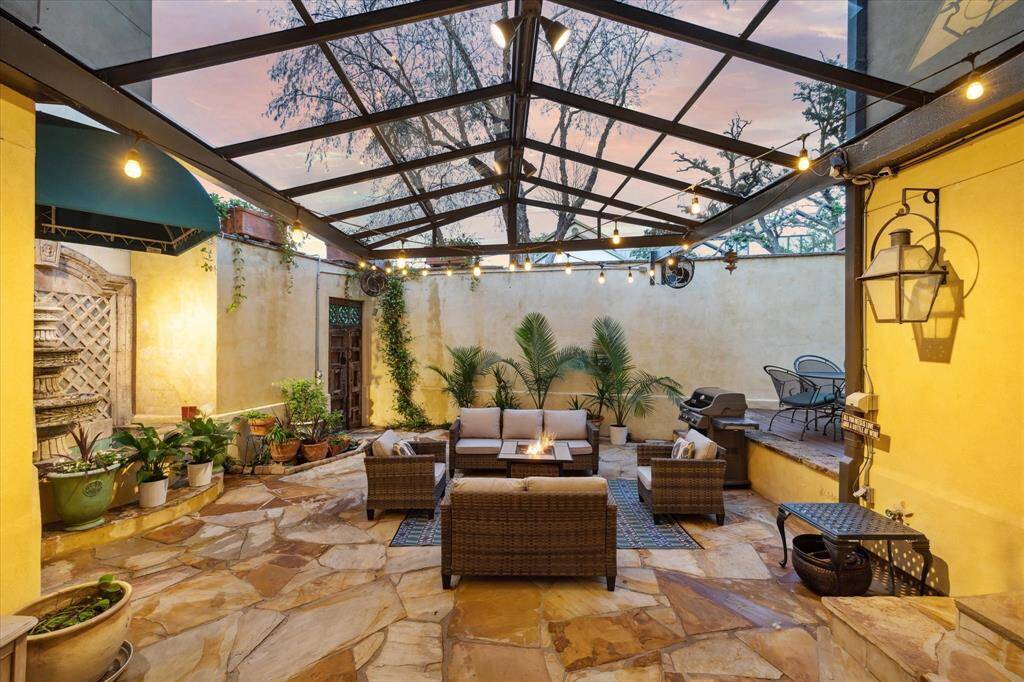 Step out onto the covered patio space. At right, room for a dining table at chairs.