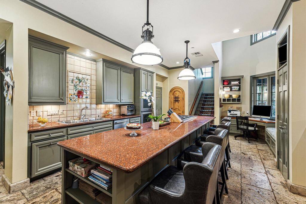 Kitchen also features double ovens, tons of storage, built in desk area and wine room.
