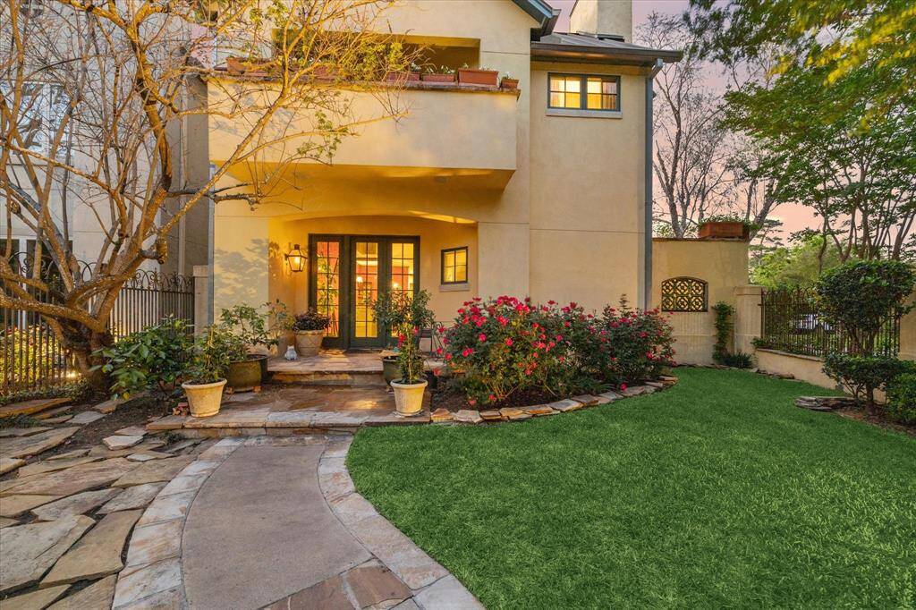 Fenced in front yard has green space.