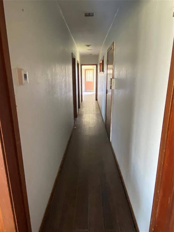 Unit 1 Hallway, leads to kitchen, bathroom, and one bedroom