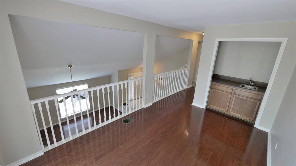 2ND FLOOR BONUS ROOM LOOKING DOWN STAIRS