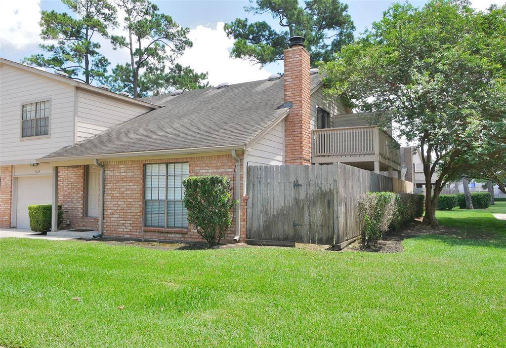 FRONT OF THE HOUSE WITH SIDE YARD AND PATIO