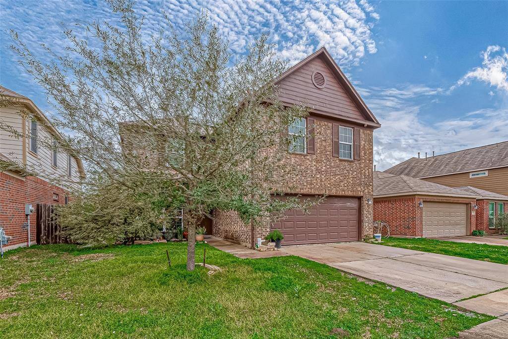 The front lawn stretches generously, offering an open, welcoming approach to the home. The home's presence is both strong and elegant, setting the stage for what awaits inside.