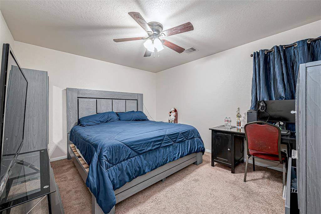 A well-proportioned bedroom that serves as a restful retreat. The plush carpet and soft lighting create a cozy ambiance, while the window allows natural light to enhance the space.