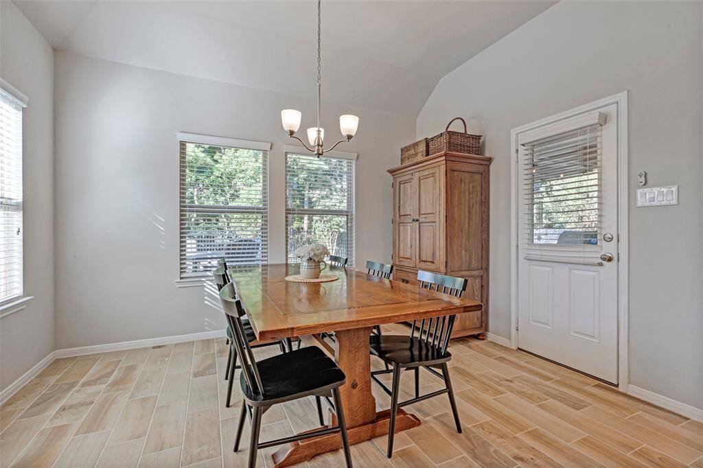 Sizeable breakfast area fits a large table and looks out into the backyard.