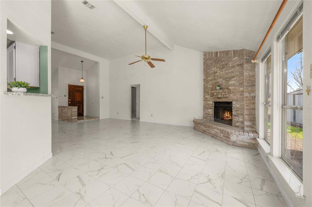 This massive 25 x 15 gathering place is enhanced by this handsome, beamed vaulted ceiling that makes this tremendous room appear even bigger than it already is.