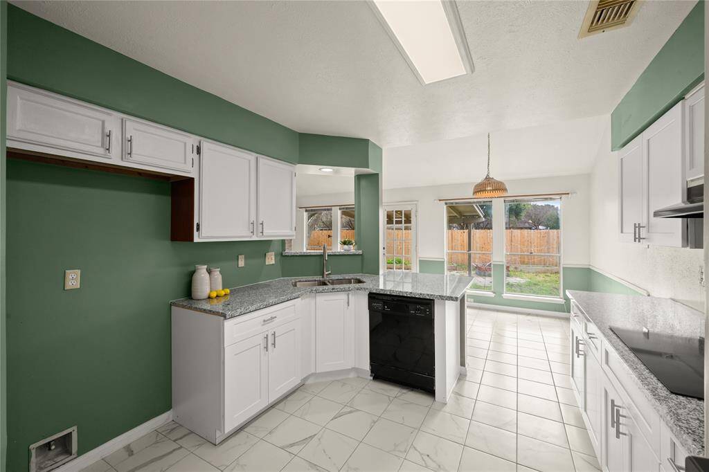This view shows the huge amount of storage and counter space supplied by this super functional kitchen. More storage is provided in your sizeable pantry just behind us.