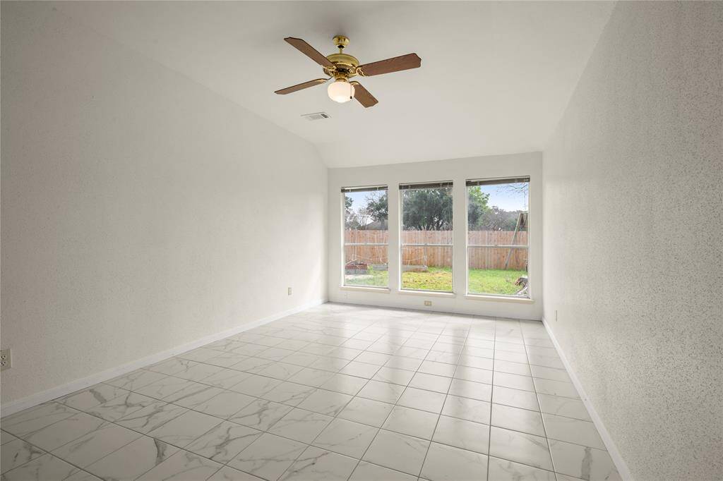 This very large 11 x 19 primary retreat with high ceilings has a gorgeous view of the backyard through these floor-to-ceiling windows that permit natural light to stream across this splendid floor.  You can only see a part of the recently replaced, 2024 side and rear fence.