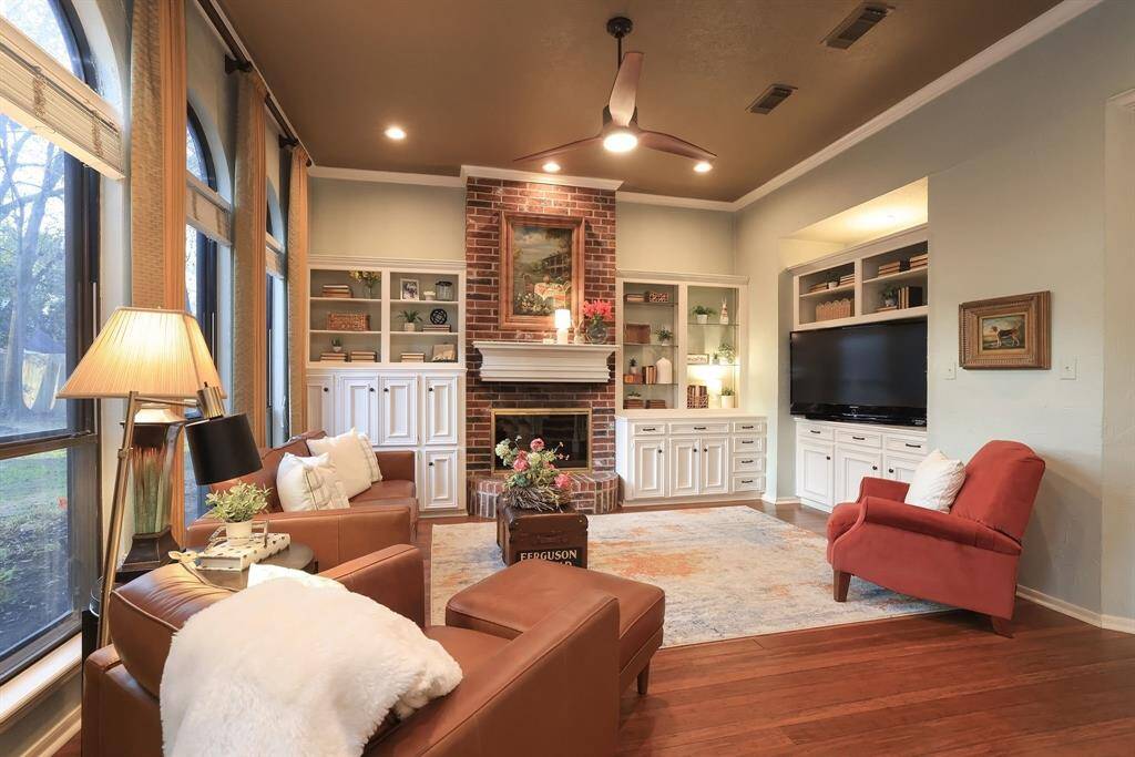 Cozy on up to the gas fireplace and enjoy its warmth and ambiance.  Situated on each side of the fireplace are built in bookcases with wonderful custom cabinets for storage galore!