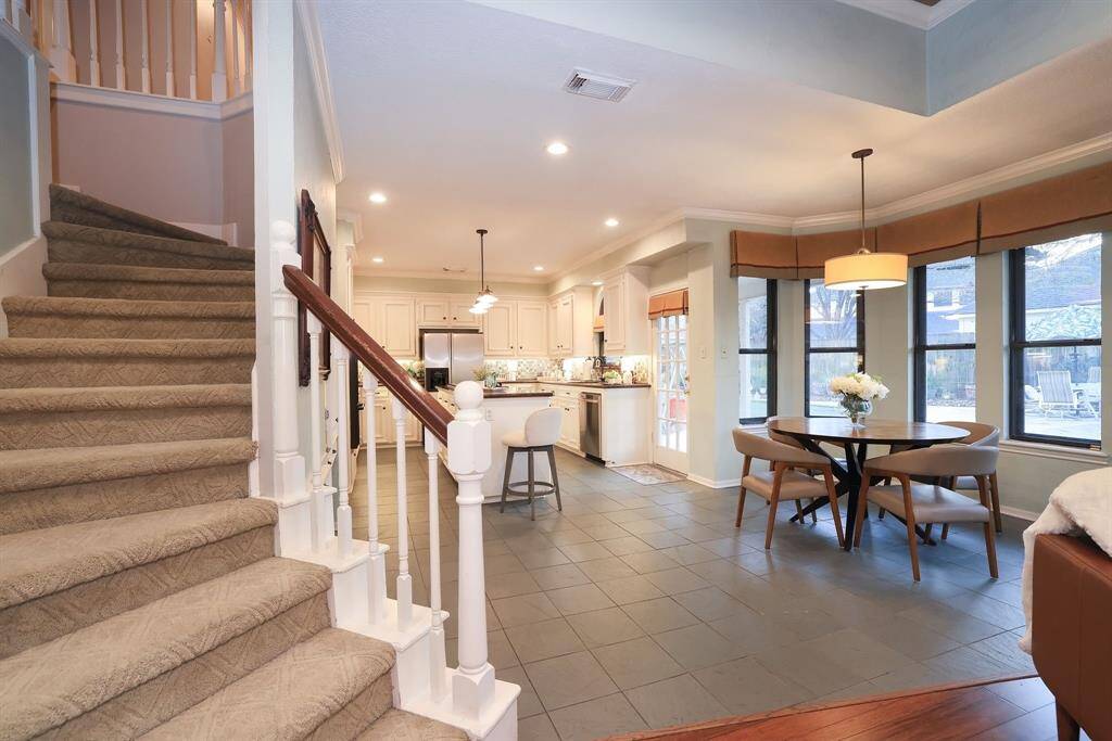 This open breakfast area is an inviting space that seamlessly blends style with comfort.  Grand windows surround the space offering amazing views of the backyard.  This is the perfect place for daily dining with your family chatting about your day!