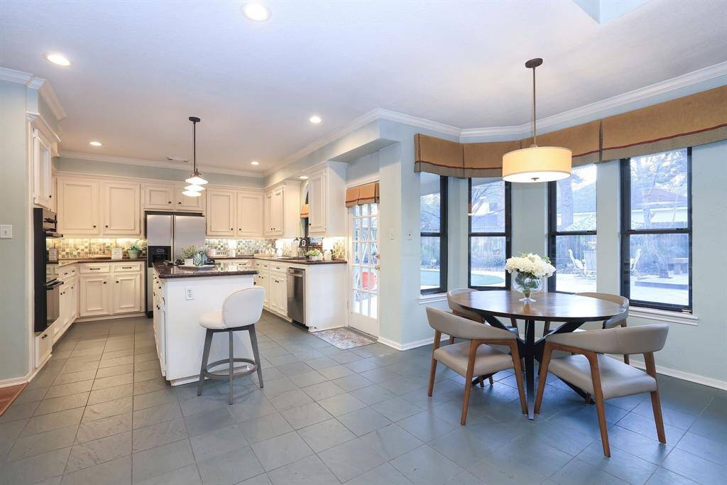 The breakfast nook opens gracefully into the kitchen creating a sense of flow and connection throughout.   Tile flooring, pendant lighting and a small built in desk to the left (not pictured) are some added features.