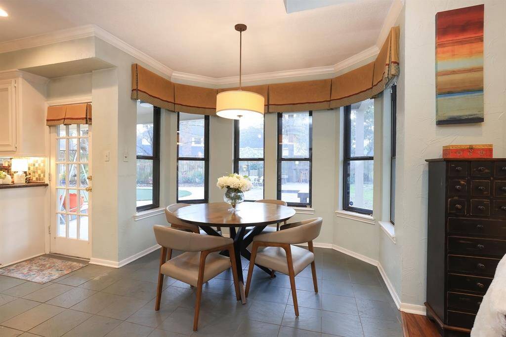 Another photo of the breakfast area with a rotunda of windows and a French door to the left for entrance to the covered patio and fun filled back yard!