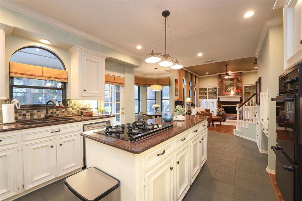 Notice how the kitchen and eating area converge together seamlessly for entertaining!  Just short (on the right) of the 2nd staircase is a small hall with a walk in pantry and good size laundry.  This house has amazing flow!