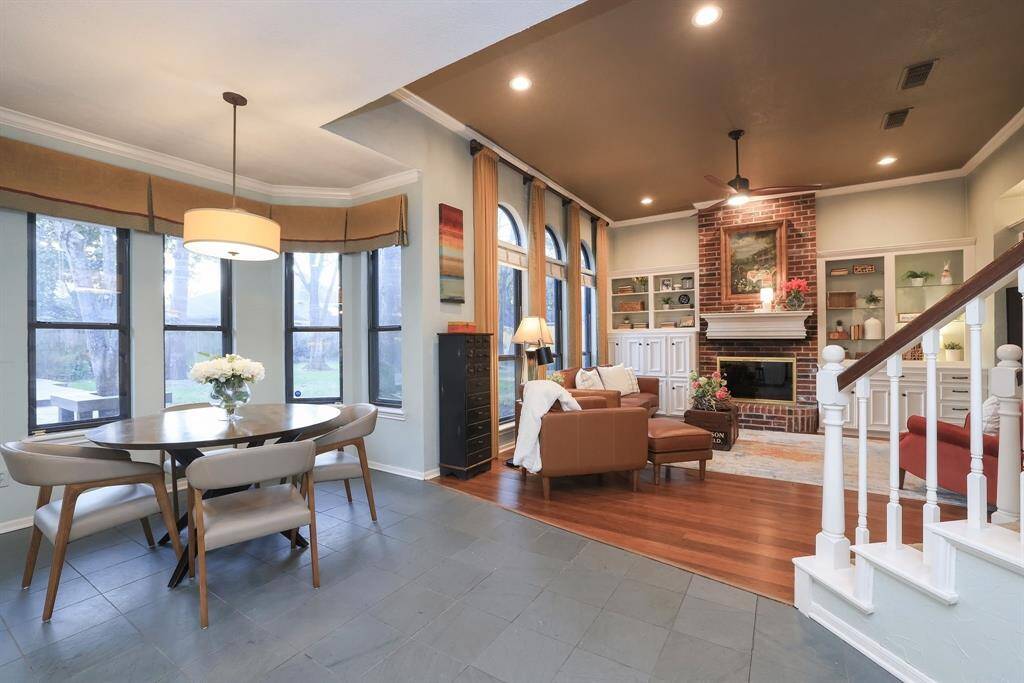 Here's a view of the eating area leading into the family room with a wall of windows overlooking the fabulous backyard!