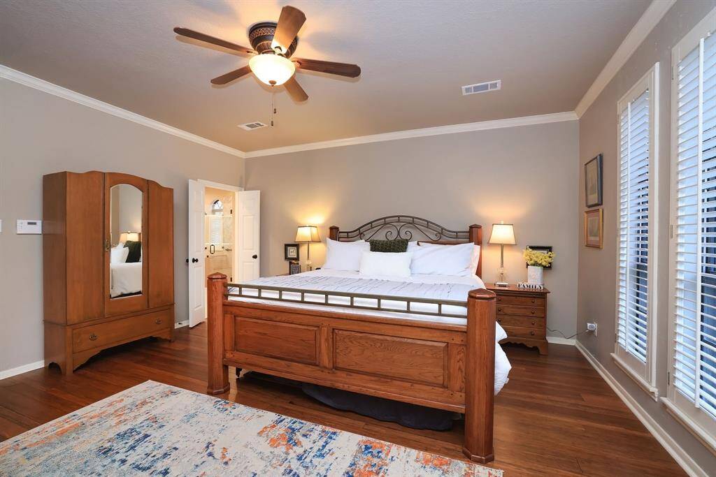 This view shows the entrance to the newly remodeled primary bath.  Notice the plantation shutters to the right.  These windows have beautiful scenes of mature trees and landscaping!