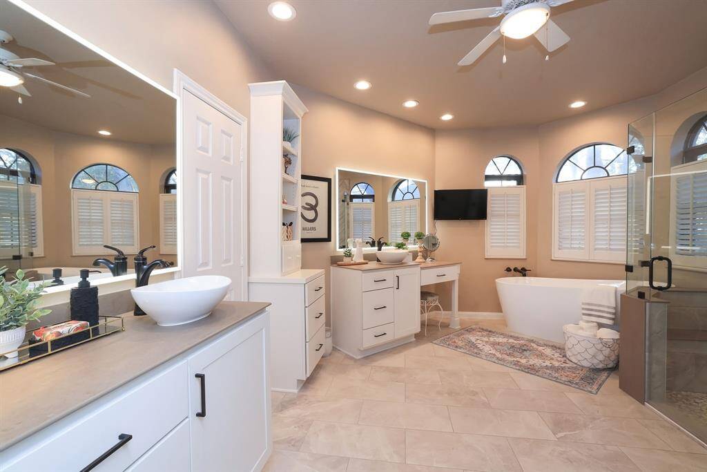 The Sellers added two (2) vanities with the most amazing mirrors that light up!  Amenities include black faucets and hardware, vessel sinks, quartz countertop, lighted ceiling fan, recessed lighting, a cozy place to sit and do makeup and a array of cabinet space for all your personal items!