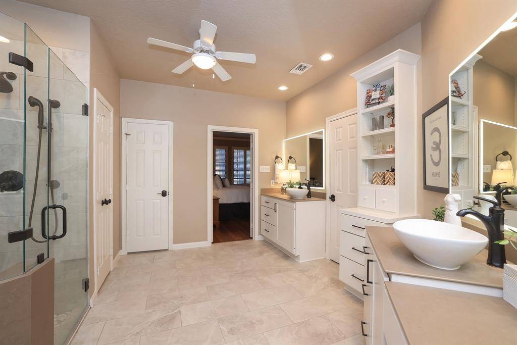 Here is a photo of the beautiful tile flooring that fits the space perfectly.  The walk in shower is an amazing space to unwind.  Frameless shower door, Dual shower heads (one is handheld), stone pebble flooring and more!   There are two (2) walk in closets!  WOW!