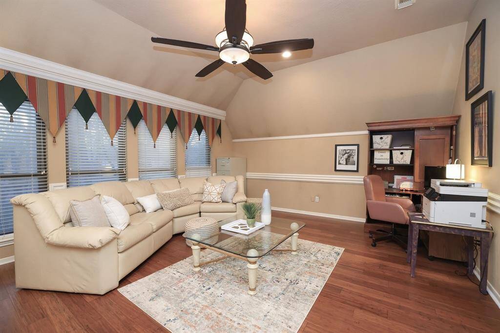 No matter our age, we always want a room for fun!  This great Game Room has beautiful wood flooring and high ceilings.  The wall of windows have an expansive view of the homes back yard!   Create your own ultimate entertainment space!