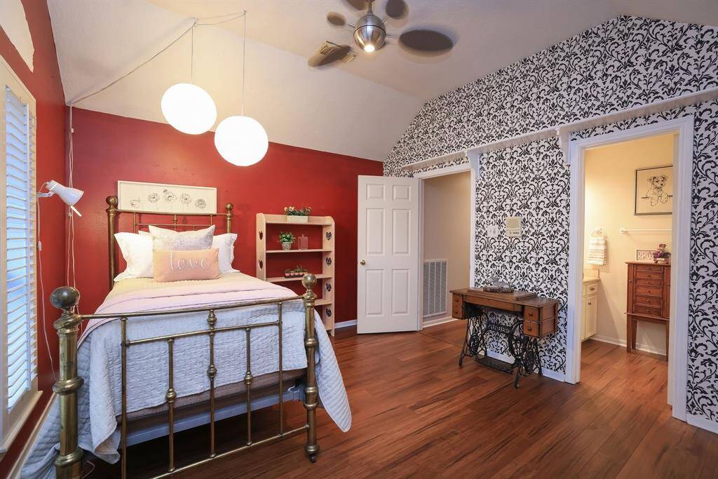 Another look at the 2nd bedroom up.  This room has a Jack and Jill Bath that connects to Bedroom #3.  Love this wallpaper as it ads a cool vibe to the room!  Also notice the custom built shelf that expands the wall.