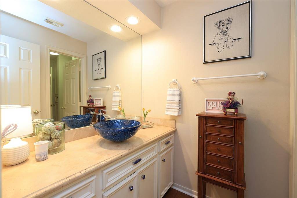 The 2nd full bath has a full length mirror from wall to wall, recessed lighting, wood flooring and a full vanity with tons of counterpace and a vessel sink.  Has maximum cabinet space for your towels and bath sponges!