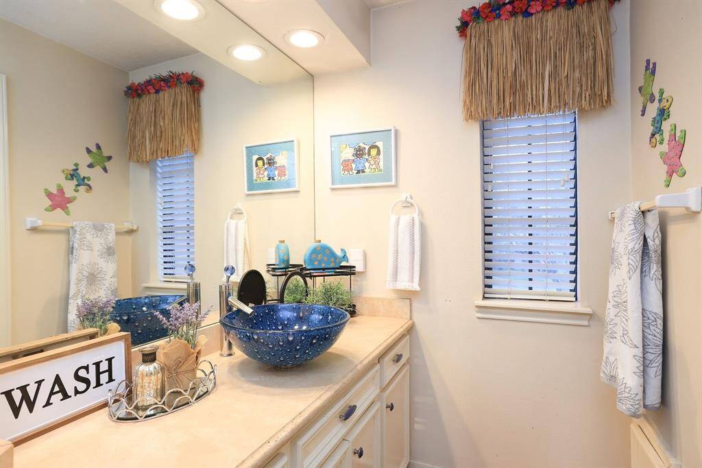 This is the other part of the Jack and Jill Bath that also features the large countertop, vanity sink, recessed lighting, and large mirror!  This bath also has a built in linen cabinet for sheets and towels!