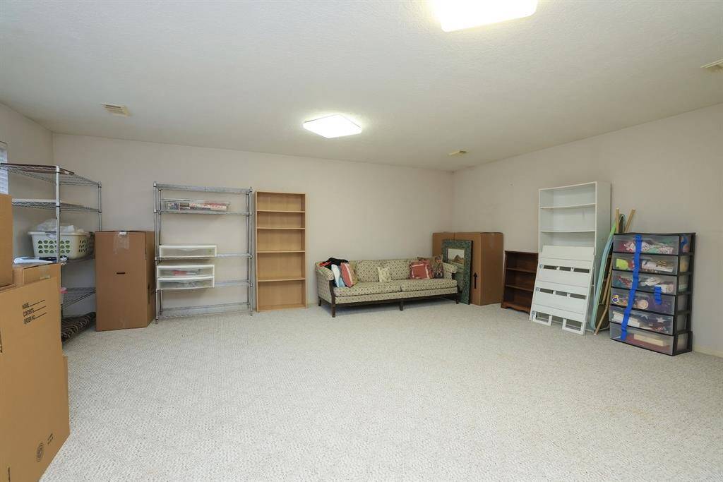 At the end of the hall is this LARGE FABULOUS room that is now being used for storage items like seasonal decorations, boxes, & old furniture.  Just imagine having a room like this to store those items!  This room could also be used as a bedroom with walk in closet and windows facing the front exterior!
