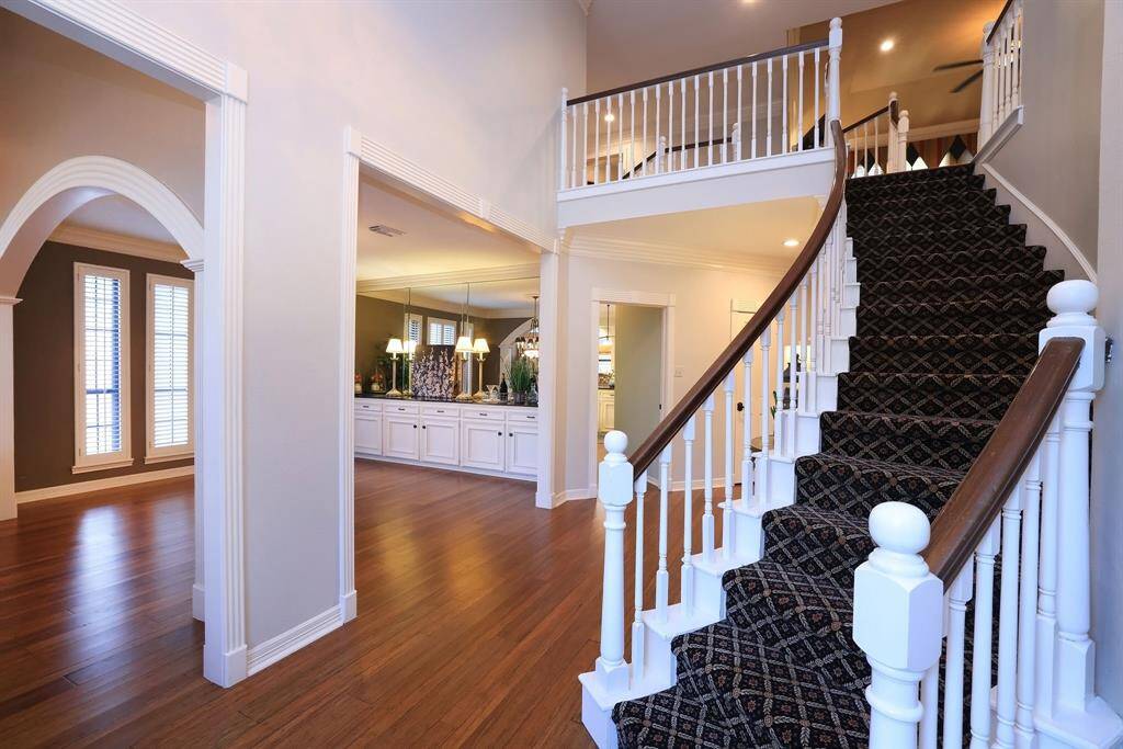 One of two sweeping staircases is located to the right of the entry and leads to 4-5 bedrooms, one being now used as a home office and the other a mammoth storage room!  The Game room is also located at the top of the stairs.