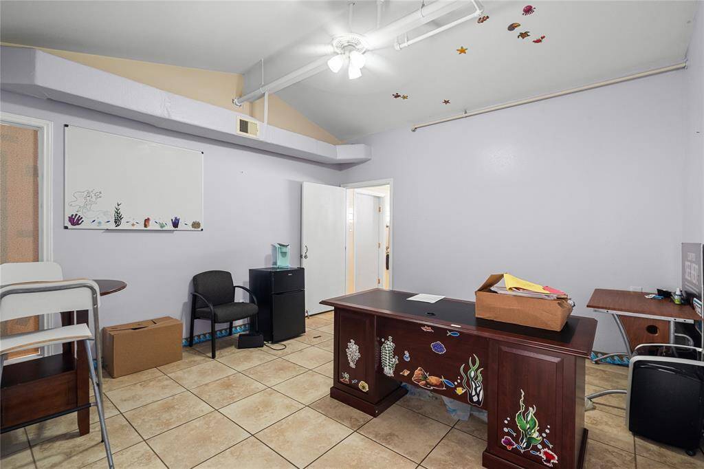 This massive room with a vaulted ceiling could be used as an office, classroom, or even a bedroom. Features include neutral tile floors, and a ceiling fan!