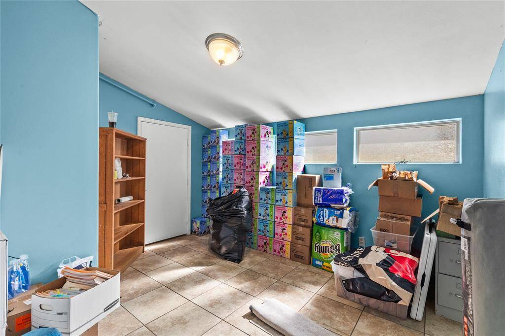 The spacious room offers acomfortable retreat from the main areas. Feautures include horizontal windows, a vaulted ceiling, and neutral tile floors.