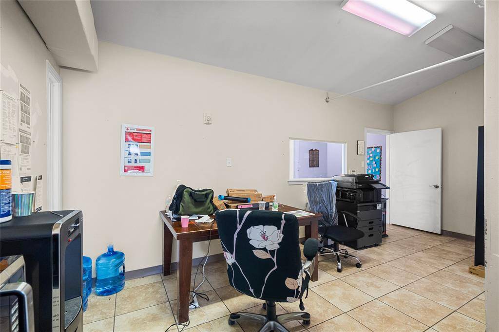 This multi purpose office space would be great for administrative tasks or for a common area. The open layout hints at the room's flexibility to accommodate various functions.