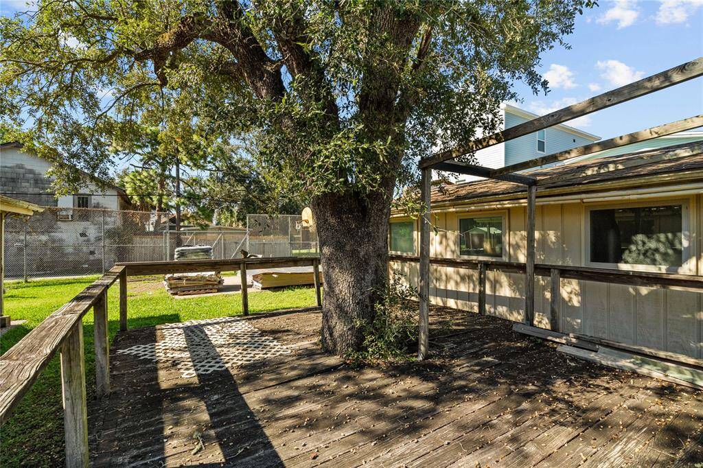 Stepping out into the backyard, you are greeted by a deck that is partially shaded by a large tree. This spacious deck provides an outdoor space for relaxation, entertaining, and enjoying the fresh air and natural surroundings.