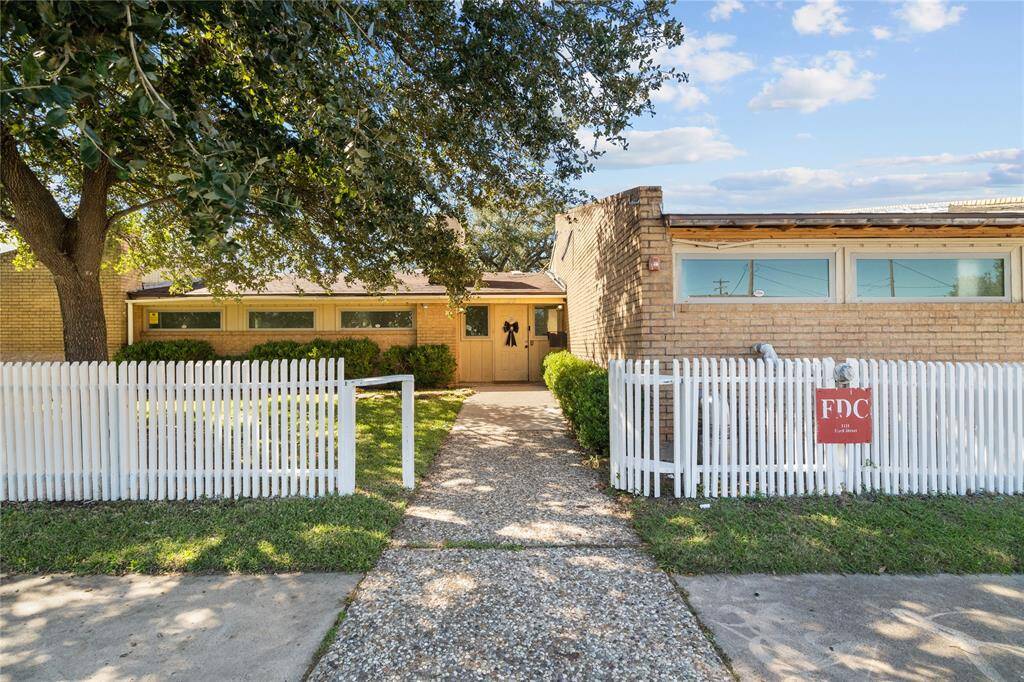 A paved walkway leads to the entrance, offering a welcoming feel. The property’s layout and setting suggest versatility, making it well-suited for residential or multi-use purposes.