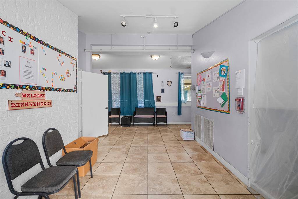Welcome in! The room features neutral tile flooring and light-colored walls, creating a bright and functional environment.
