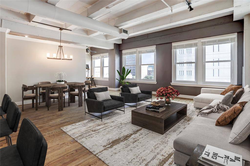 Here’s another view of the living space, taken from the kitchen island. From this angle, you can appreciate all 6 windows, letting in tons of natural light and creating a bright, inviting atmosphere. This photo is virtually staged.