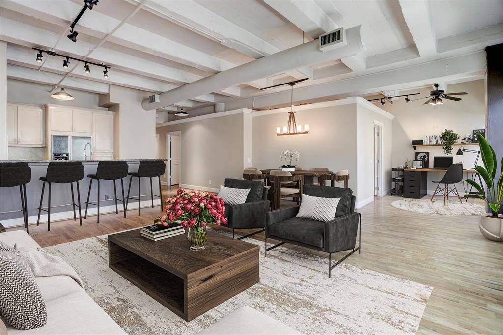 The space to the right in this photo would be ideal for a cozy office or a peaceful reading nook. The two doors visible here lead to the bedrooms, offering privacy and a quiet retreat. This photo is virtually staged.