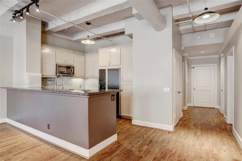 Take in the views of the kitchen and the foyer, which leads to the main entrance of the unit. The kitchen’s open design offers a seamless flow into the living space, while the foyer provides a welcoming first impression as you enter your home.