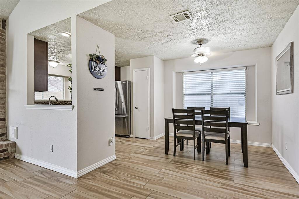 Open concept floor plan leads you from the living room to the dining room and kitchen