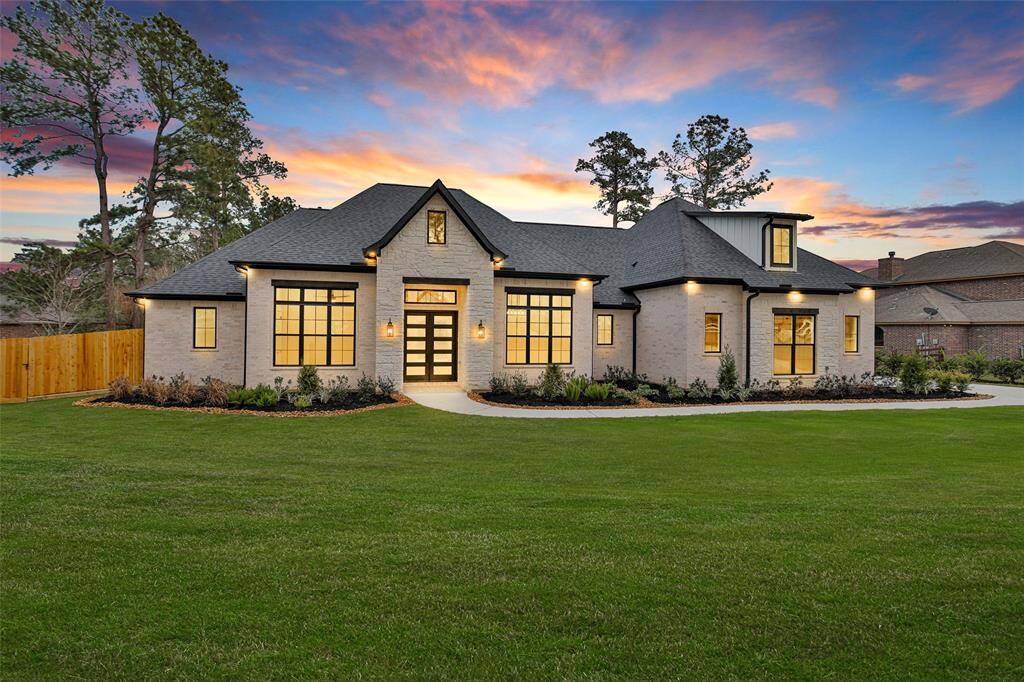 A beautiful front view of the home, showcasing a well-maintained 1.2-acre lot.