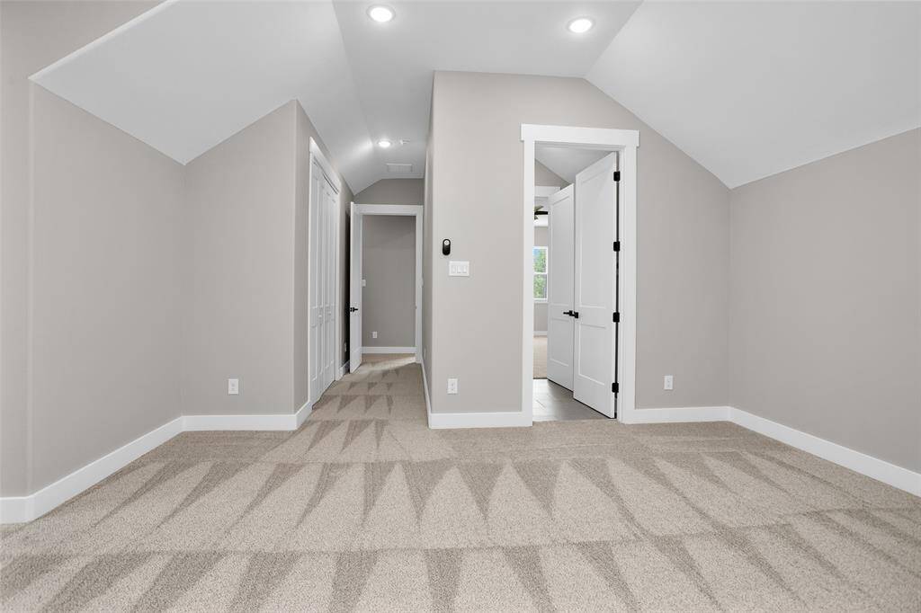 A versatile bonus room, perfect for use as a home office, game room, or media room, with large windows and neutral flooring